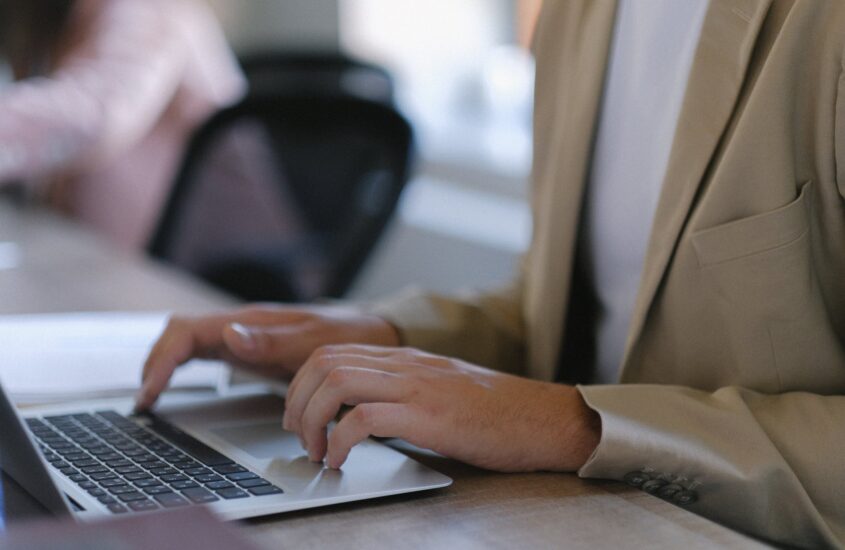 crop man typing on laptop