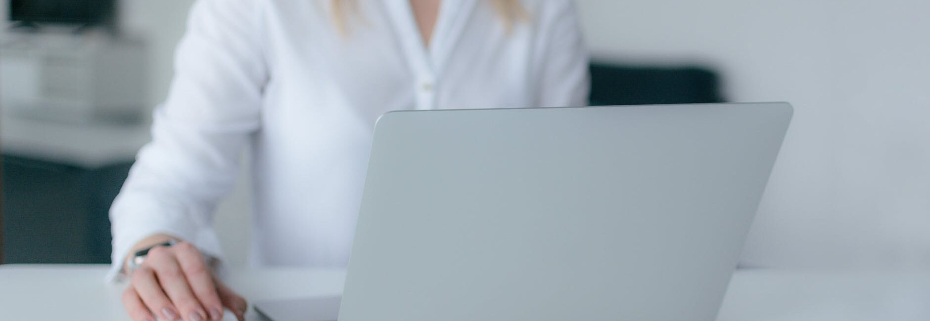 woman using silver laptop