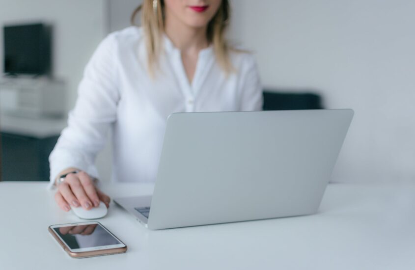 woman using silver laptop